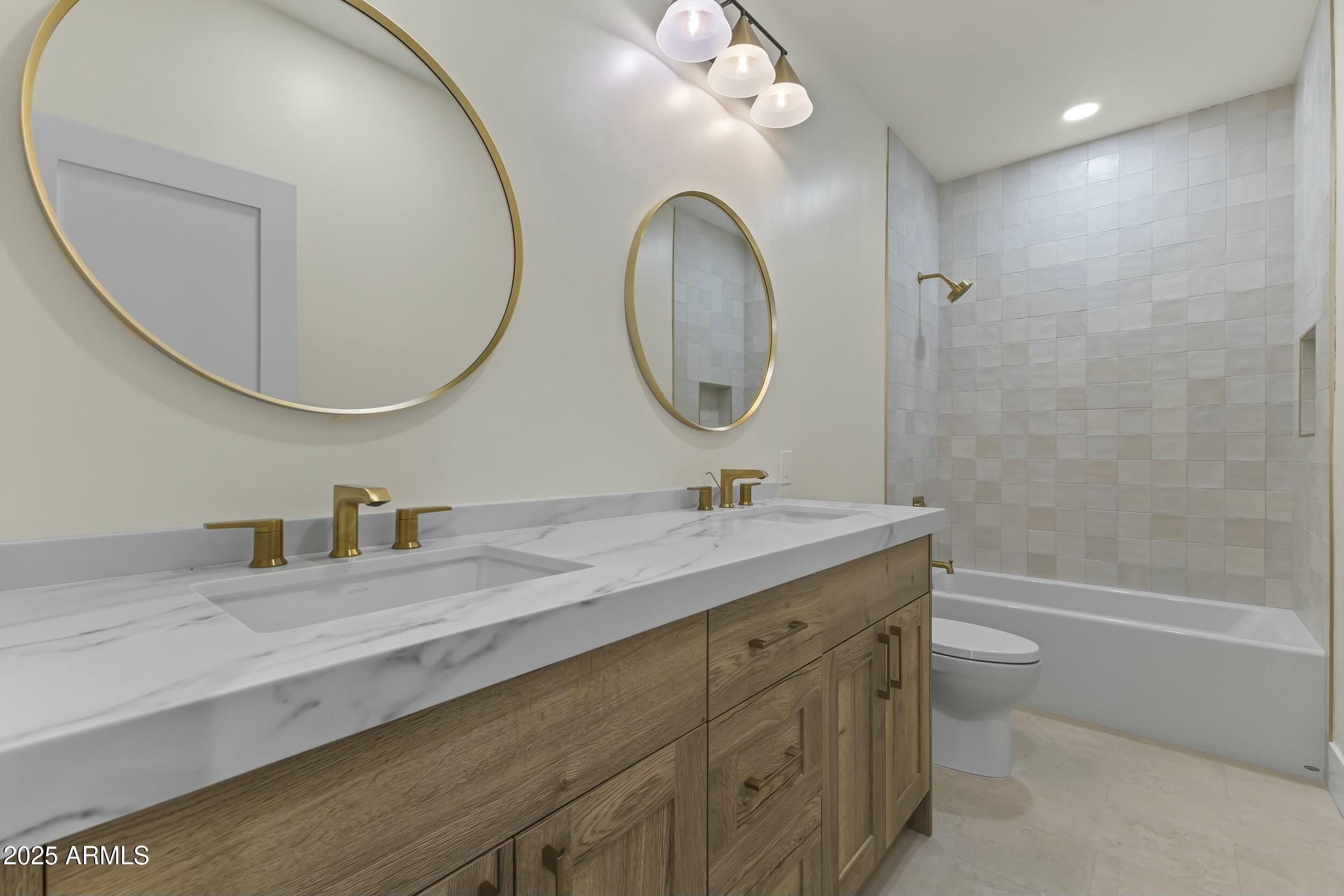 7705 East Doubletree Ranch Road, Unit 21 Scottsdale, AZ 85258 - Photo 7 of 45 a bathroom with a granite countertop toilet a sink and a mirror