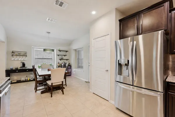 a kitchen with stainless steel appliances granite countertop a refrigerator and a refrigerator