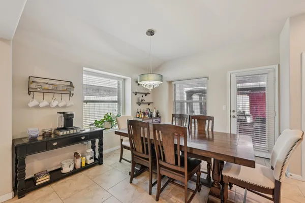 a view of a dining room with furniture and window
