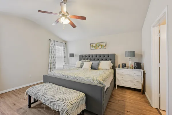 a bedroom with a bed and a chandelier