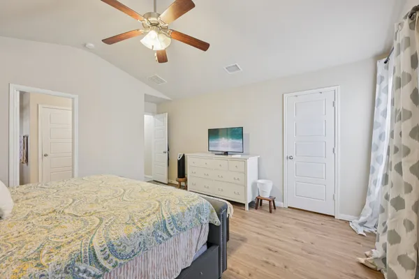 a bedroom with a bed and a chandelier