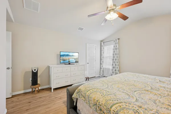 a bedroom with a bed and a dresser