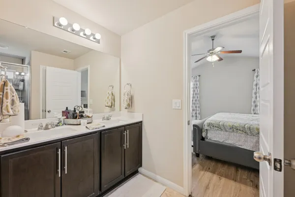 a en suite bathroom with a double vanity sink a mirror and a shower