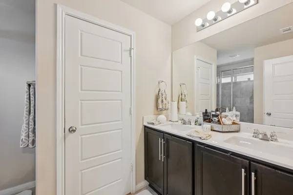 a bathroom with a double vanity sink and a mirror
