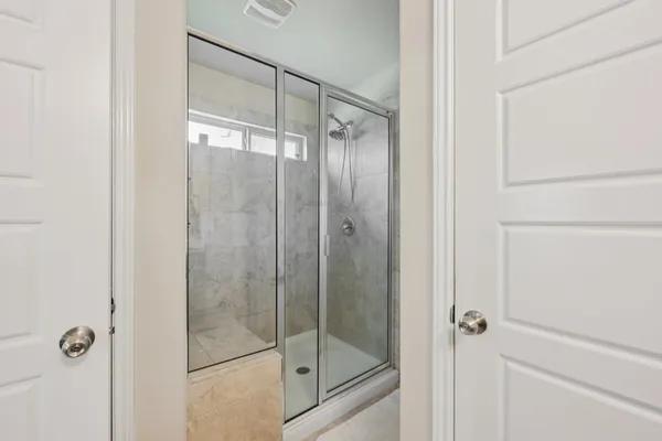 a bathroom with a glass shower door
