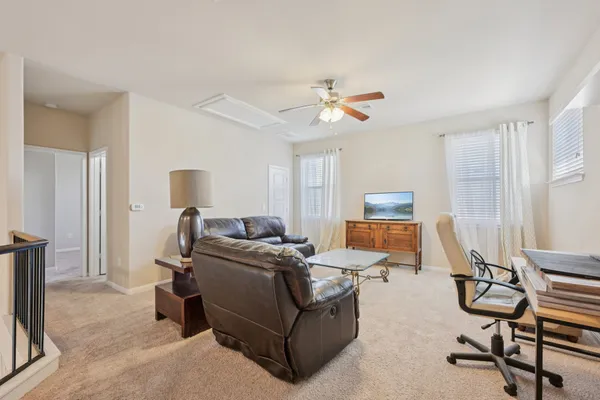 a living room with furniture a air conditioner and a window