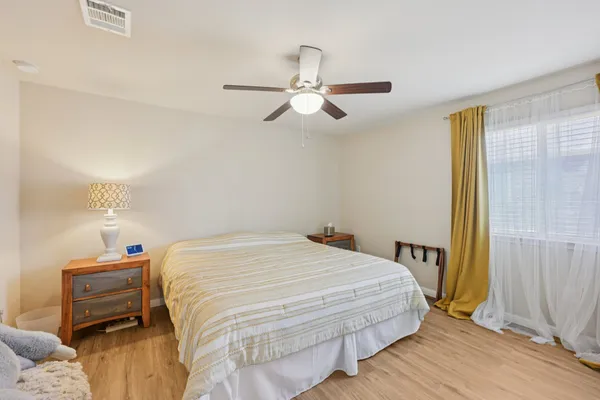 a bedroom with a bed and a chandelier