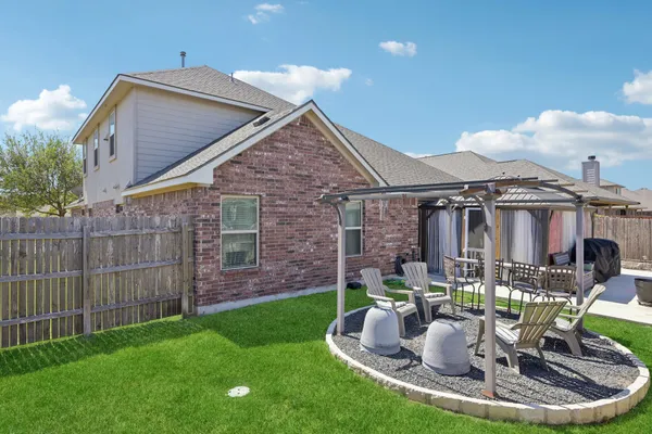 a view of a house with backyard porch and sitting area