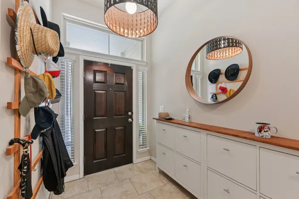 a front view of a mirror and cabinets