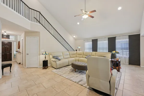 a living room with furniture and a chandelier
