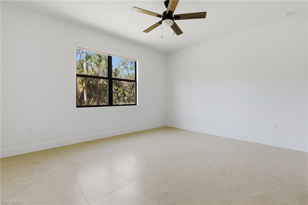 2167 Della Drive Naples, FL 34117 - Photo 14 of 38 Unfurnished room featuring ceiling fan and baseboards