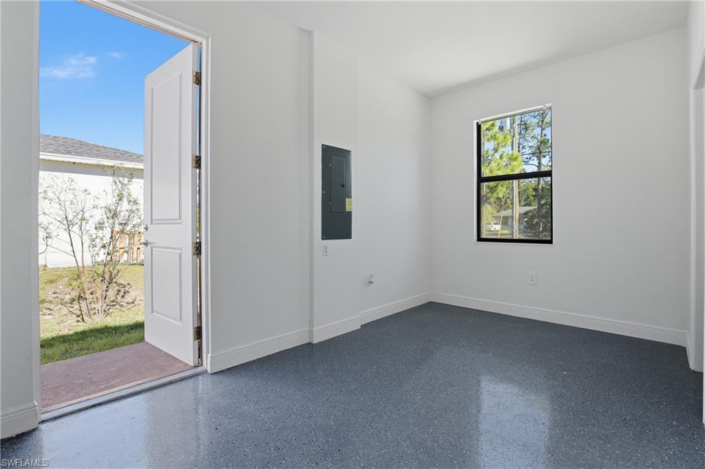 2167 Della Drive Naples, FL 34117 - Photo 26 of 38 Empty room featuring electric panel and speckle patterned floor
