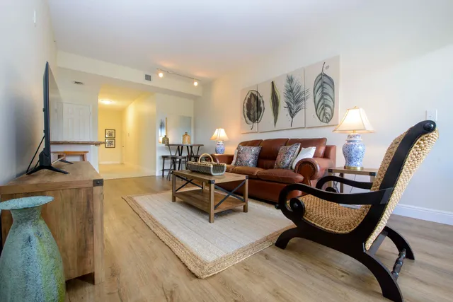 a living room with furniture and a wooden floor