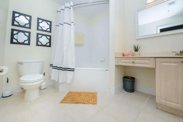 a white toilet sitting next to a bathroom sink