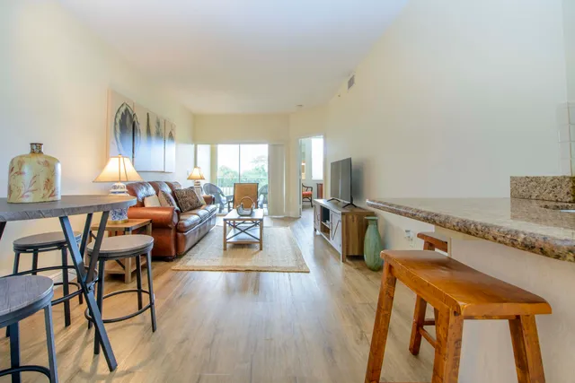 a living room with furniture a fireplace and wooden floor