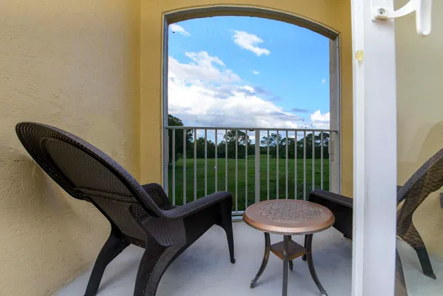 a view of a balcony with a table and chairs