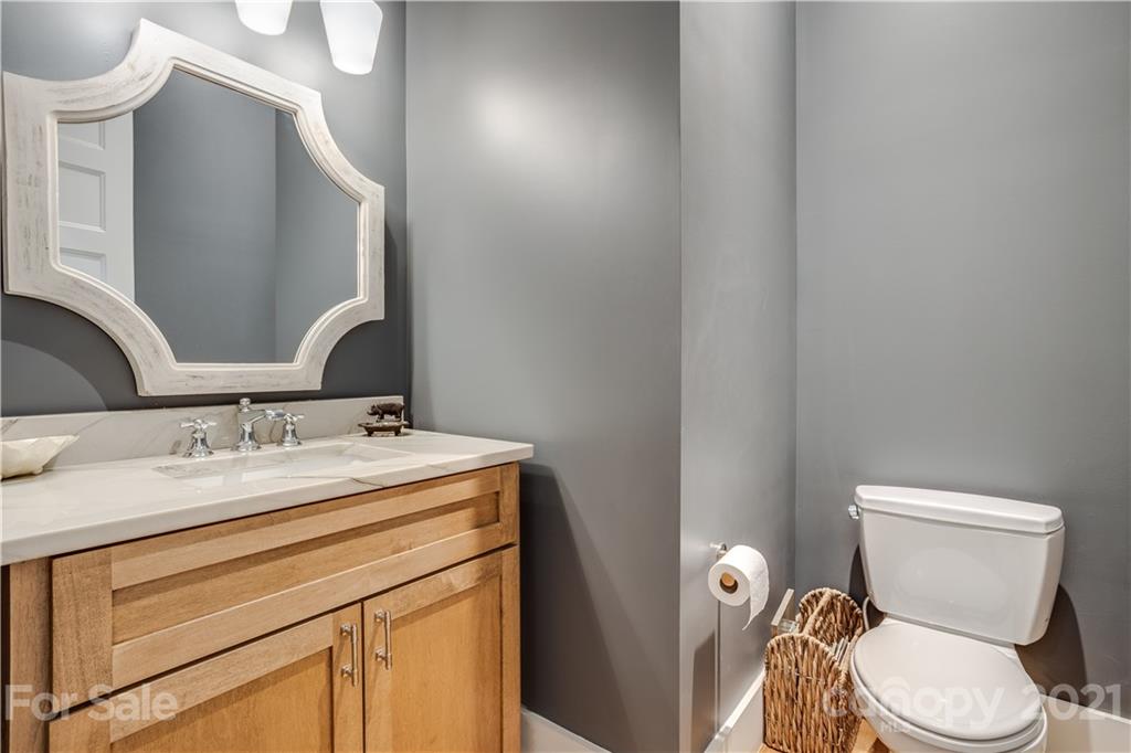 8080 Stillwater Drive Denver, NC 28037 - Photo 13 of 44 a bathroom with a granite countertop toilet sink and mirror
