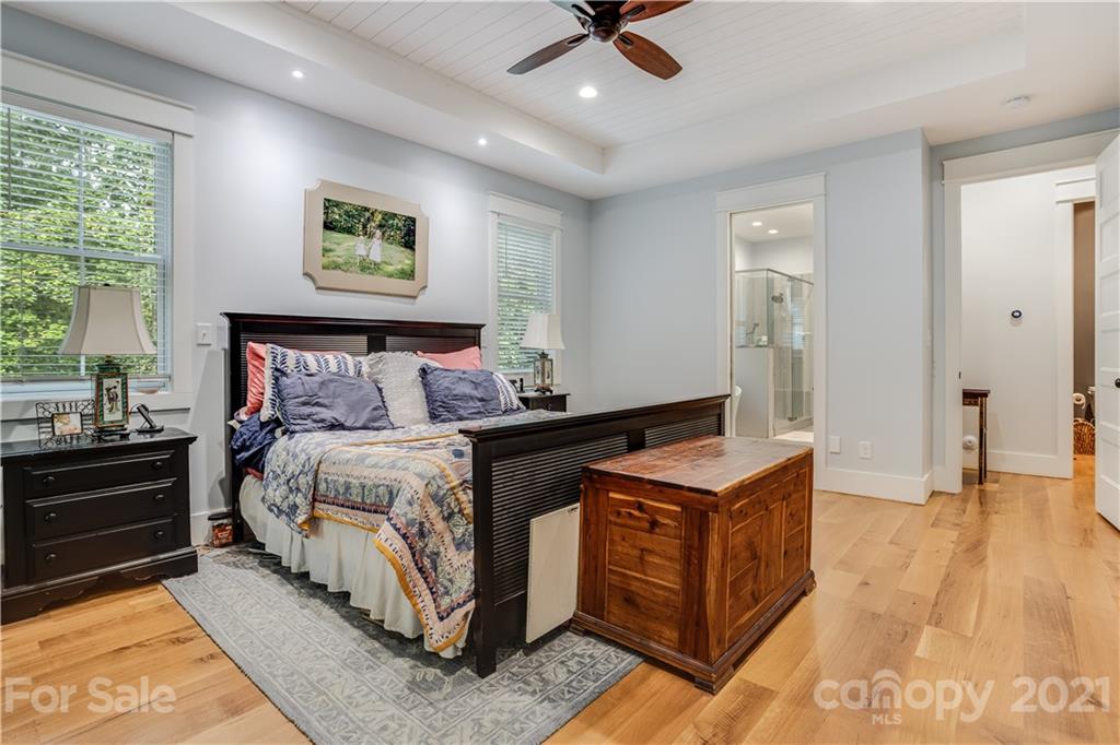 8080 Stillwater Drive Denver, NC 28037 - Photo 14 of 44 a bedroom with a bed and wooden floor