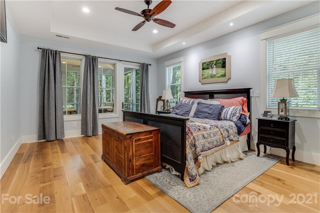 8080 Stillwater Drive Denver, NC 28037 - Photo 15 of 44 a bedroom with a bed lamp and a large window