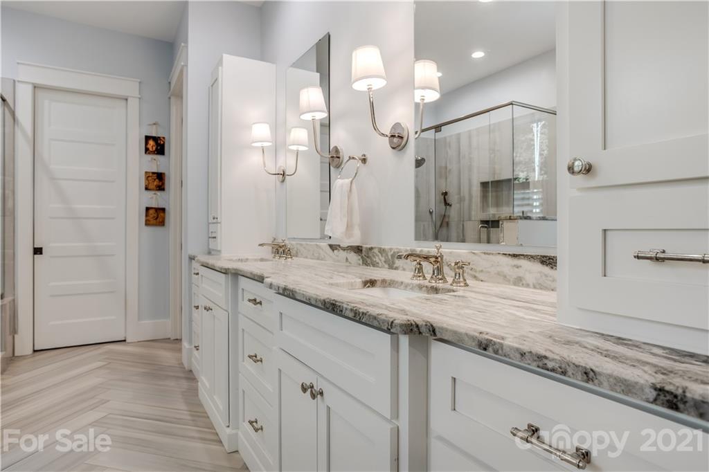 8080 Stillwater Drive Denver, NC 28037 - Photo 18 of 44 a bathroom with a granite countertop sink a large mirror and a shower