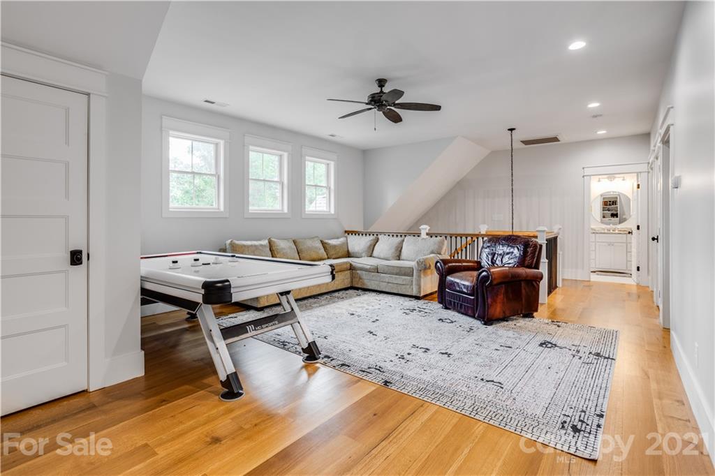 8080 Stillwater Drive Denver, NC 28037 - Photo 22 of 44 a living room with furniture and a wooden floor