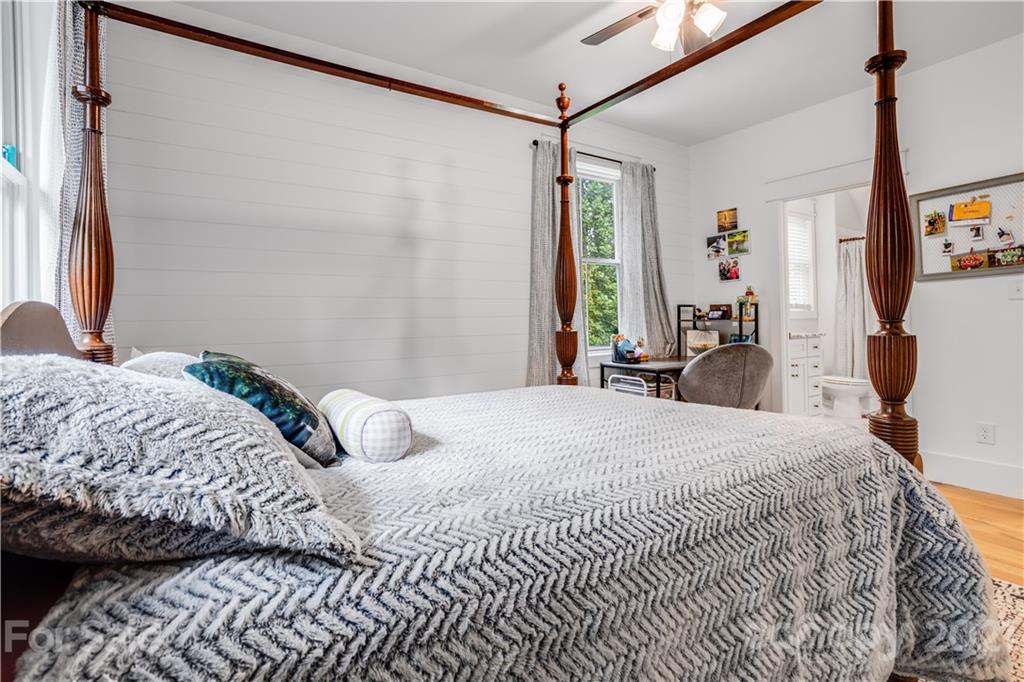 8080 Stillwater Drive Denver, NC 28037 - Photo 24 of 44 a bedroom with a bed window and a flat tv screen