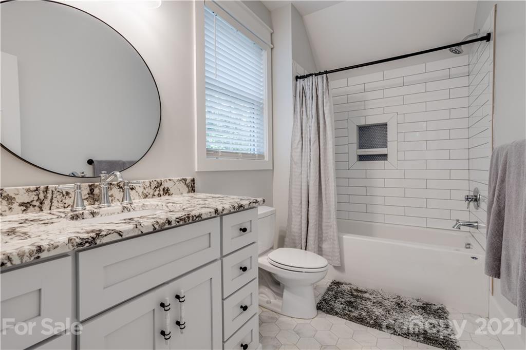 8080 Stillwater Drive Denver, NC 28037 - Photo 25 of 44 a bathroom with a granite countertop sink toilet and shower