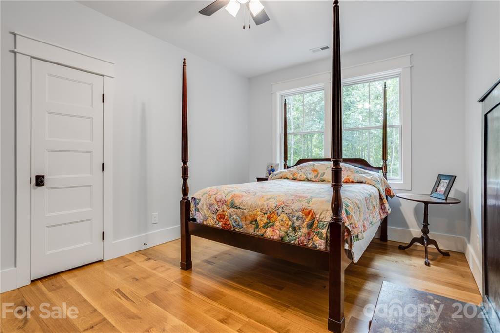 8080 Stillwater Drive Denver, NC 28037 - Photo 26 of 44 a bed sitting in a bedroom next to a window