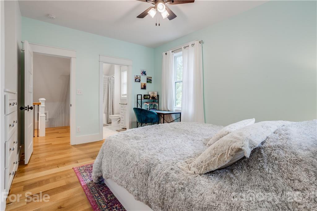 8080 Stillwater Drive Denver, NC 28037 - Photo 29 of 44 a bedroom with a bed and a chandelier
