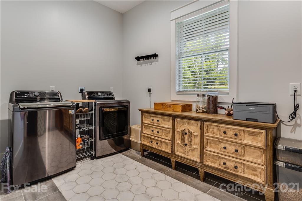8080 Stillwater Drive Denver, NC 28037 - Photo 31 of 44 a kitchen with stainless steel appliances a stove a sink and a refrigerator
