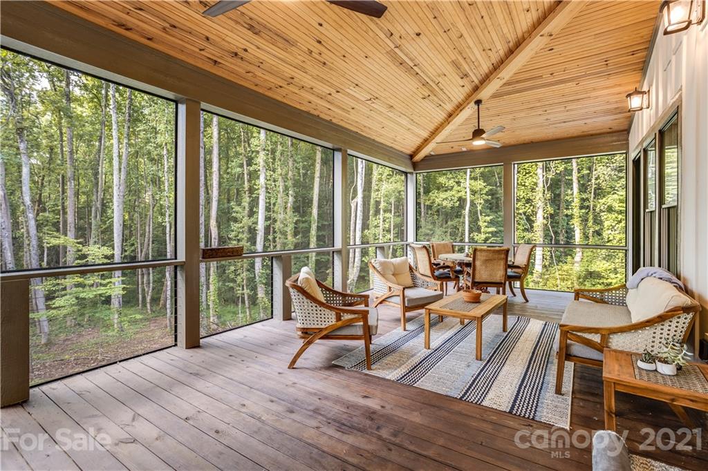8080 Stillwater Drive Denver, NC 28037 - Photo 32 of 44 a living room with furniture and floor to ceiling windows