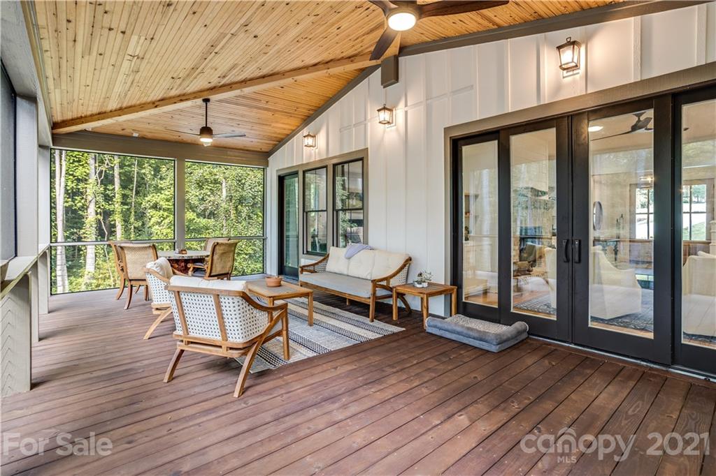8080 Stillwater Drive Denver, NC 28037 - Photo 35 of 44 a living room with a wooden floor and a table