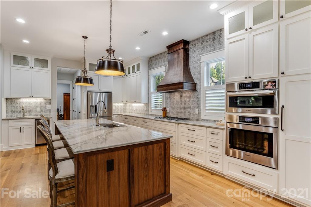 8080 Stillwater Drive Denver, NC 28037 - Photo 5 of 44 a kitchen with stainless steel appliances kitchen island granite countertop a stove a sink and a microwave