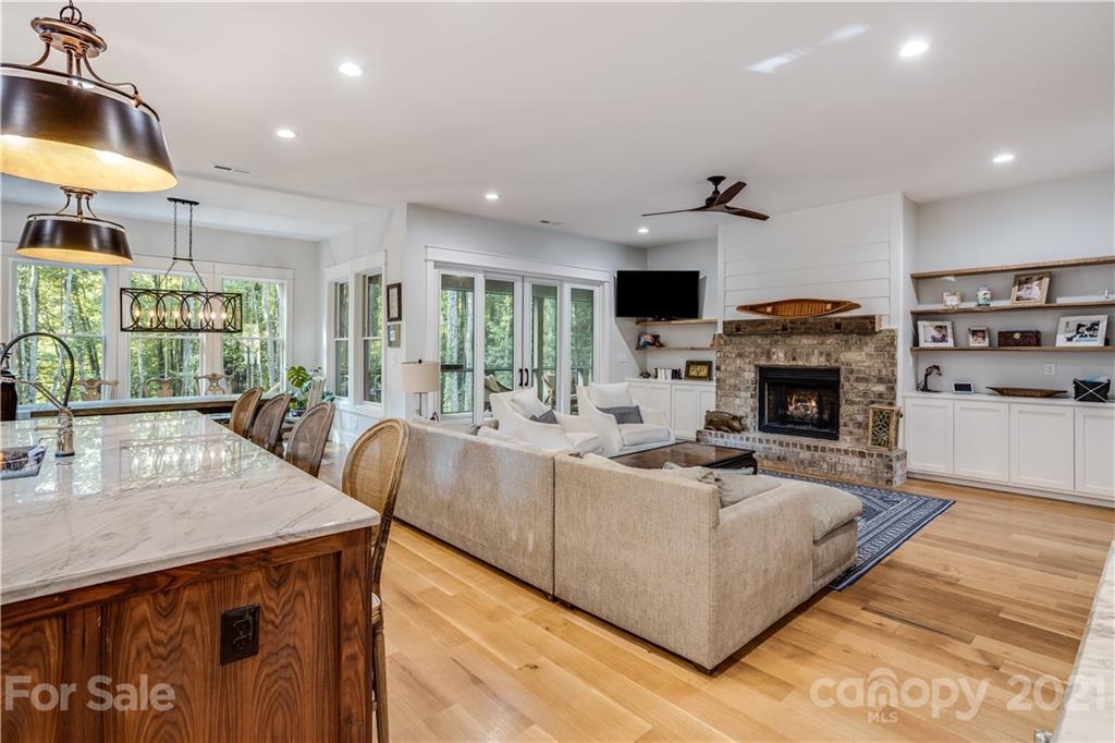 8080 Stillwater Drive Denver, NC 28037 - Photo 9 of 44 a living room with furniture a fireplace and a flat screen tv
