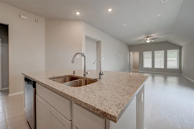 a kitchen with a sink and chandelier