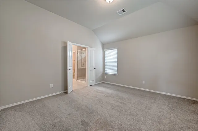 an empty room with windows and closet in it
