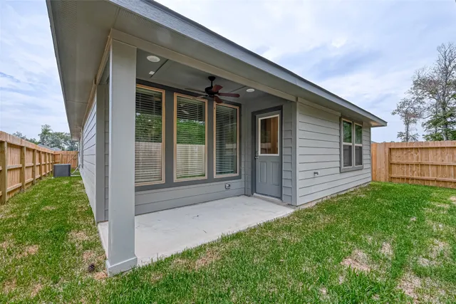 a view of backyard of house with green space