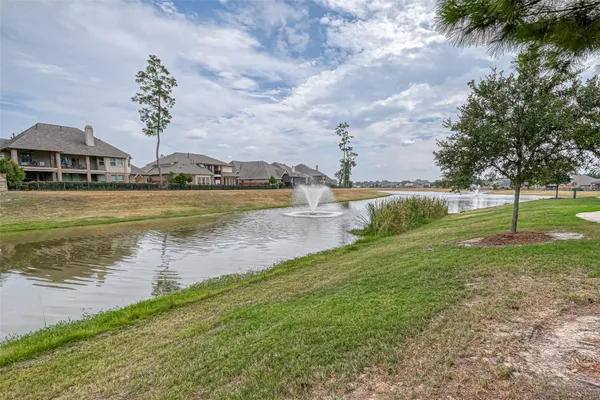 a view of a lake with houses in the background