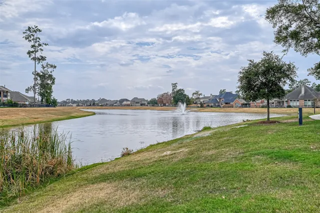 a view of a lake with houses in the back