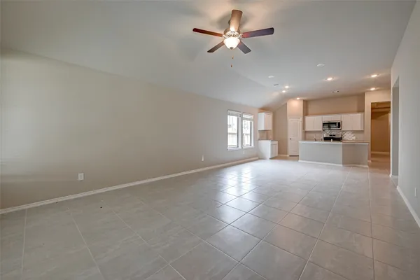 a view of a livingroom with a ceiling fan and window