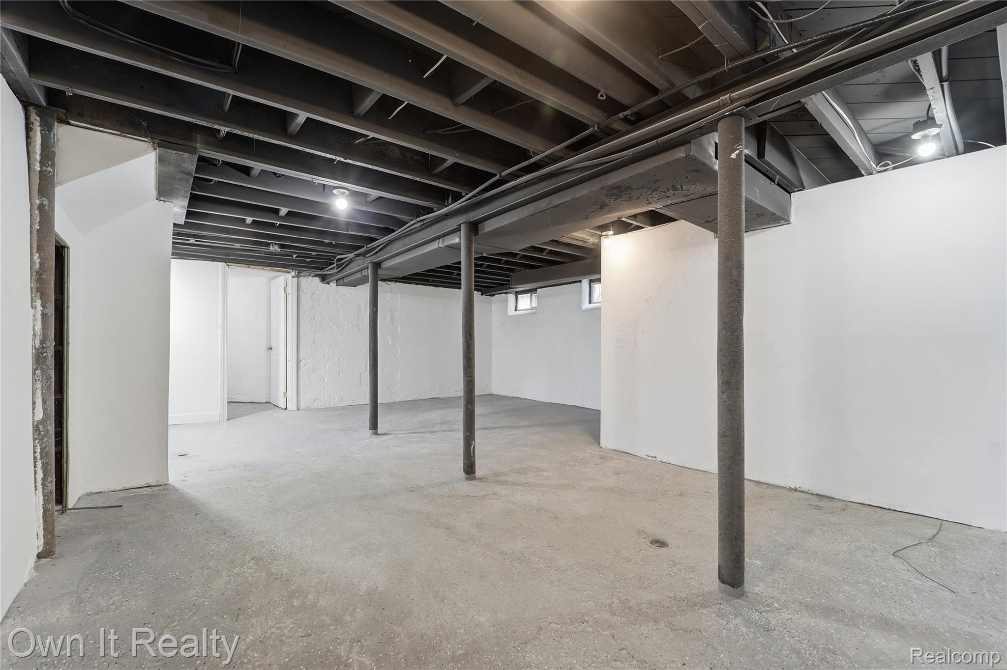17351 Appoline Street Detroit, MI 48235 - Photo 19 of 34 Expansive unfinished basement featuring concrete flooring and exposed ceiling joists