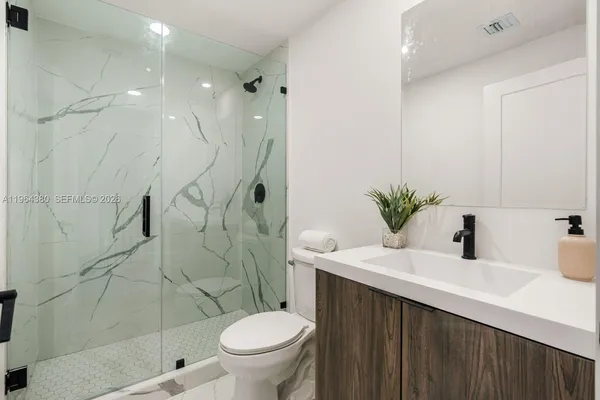 a bathroom with a sink toilet and shower