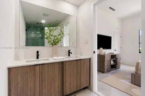 a bathroom with a double vanity sink toilet and mirror
