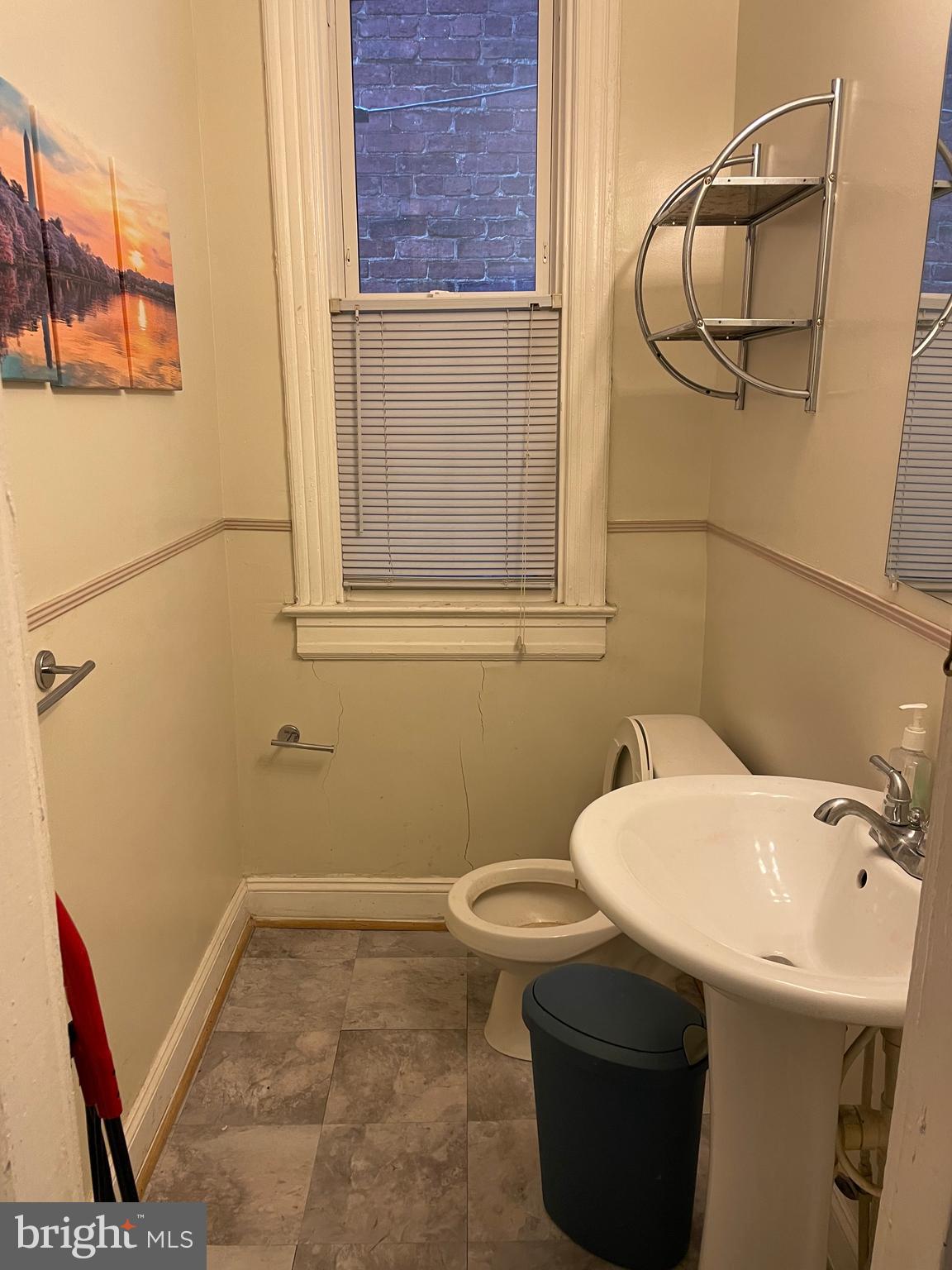 604 Irving Street Northwest Washington, DC 20010 - Photo 7 of 11 a bathroom with a sink a toilet and a mirror