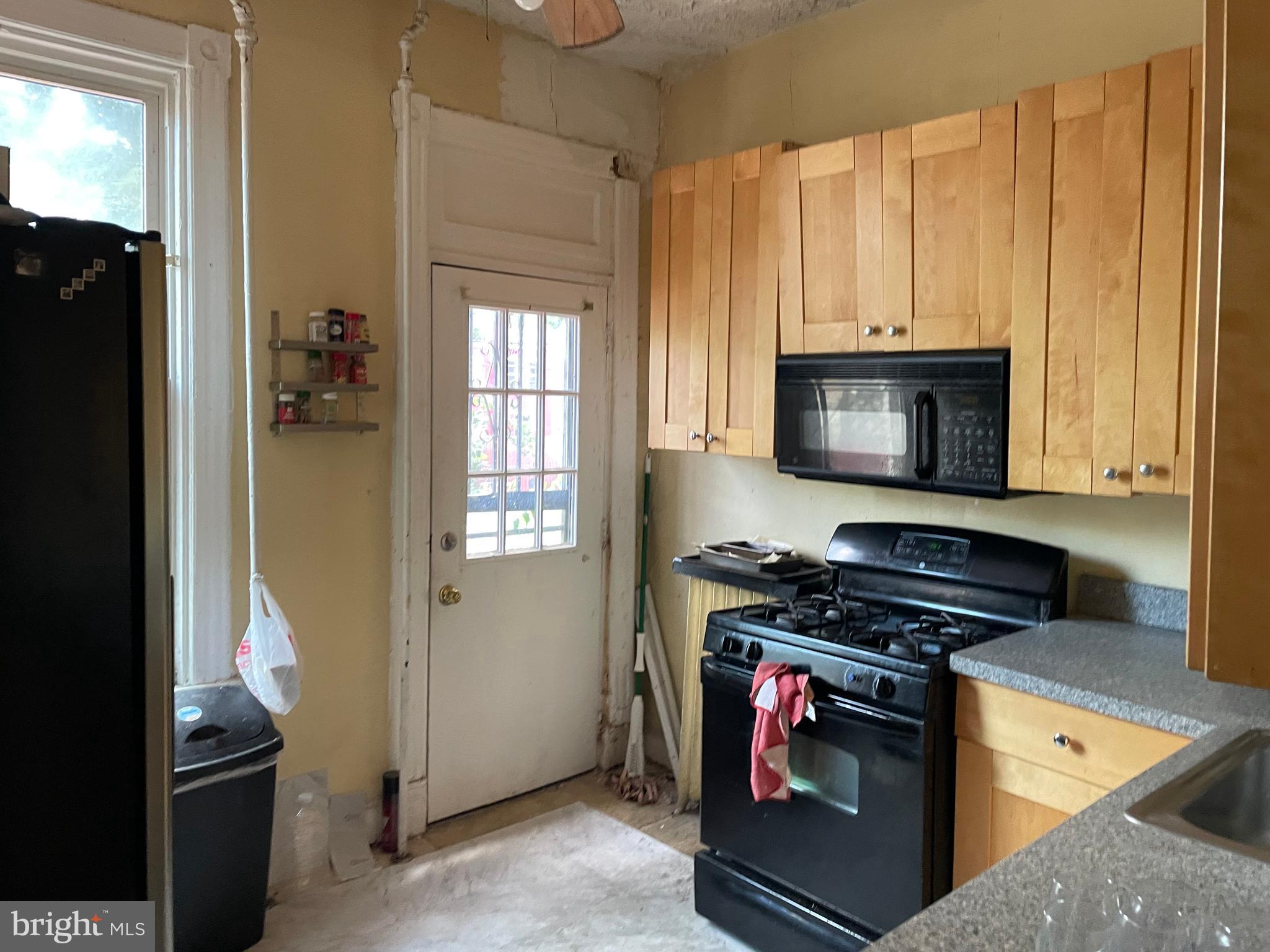 604 Irving Street Northwest Washington, DC 20010 - Photo 8 of 11 a kitchen with granite countertop a stove and a refrigerator