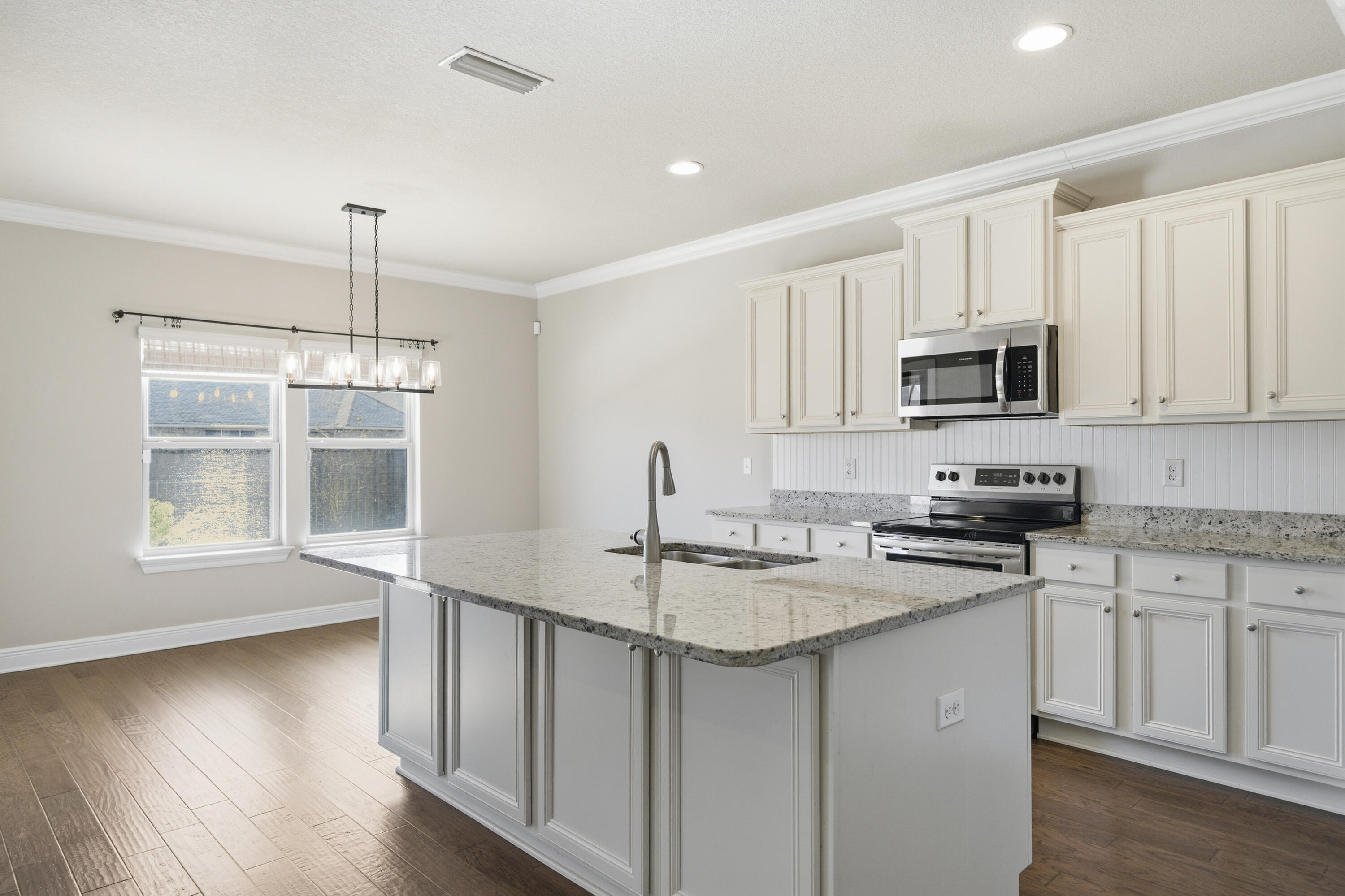 132 Wayne Trail Santa Rosa Beach, FL 32459 - Photo 14 of 43 a kitchen with stainless steel appliances granite countertop a sink stove and microwave