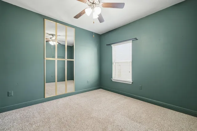 an empty room with windows and closet