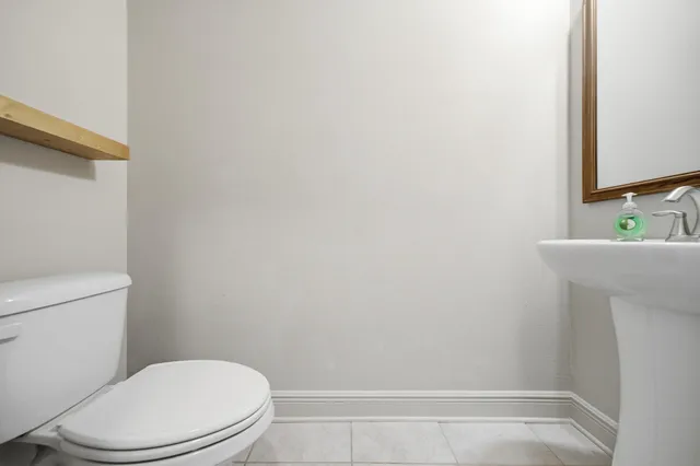 a white toilet sitting next to a bathroom sink