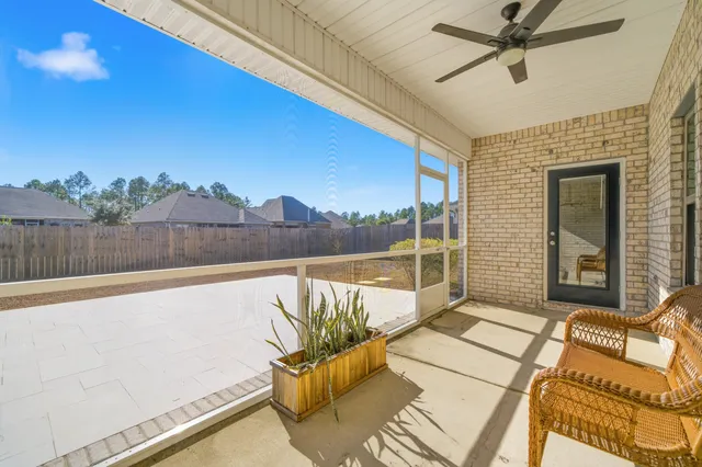 a view of a balcony with furniture and a floor to ceiling window