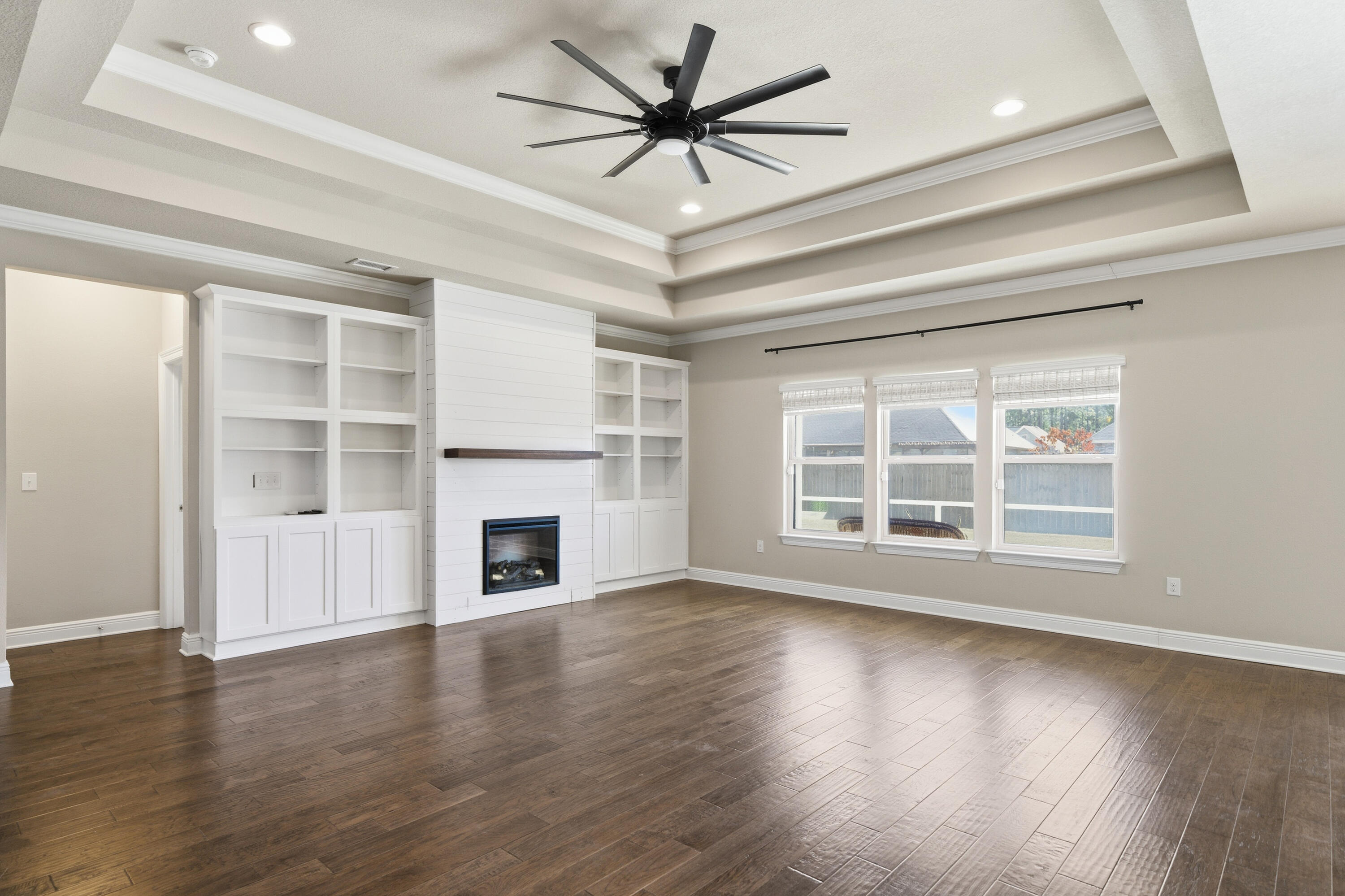 132 Wayne Trail Santa Rosa Beach, FL 32459 - Photo 5 of 43 a view of a livingroom with a fireplace a ceiling fan and windows